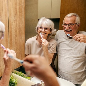 A senior couple brushing their teeth in the morning