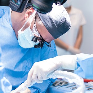 A dentist performing a dental implant surgery