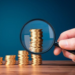 Stacks of coins examined by magnifying glass