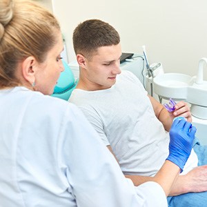 A dentist showing a mouthguard to her patient