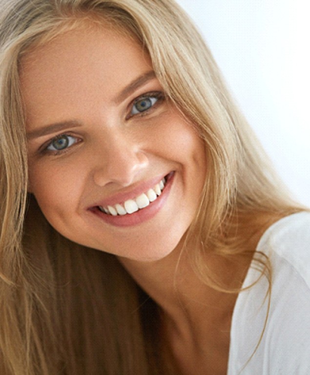 young woman smiling after getting veneers