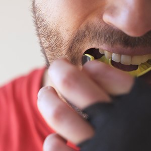 Woman biting her nails while sitting on couch