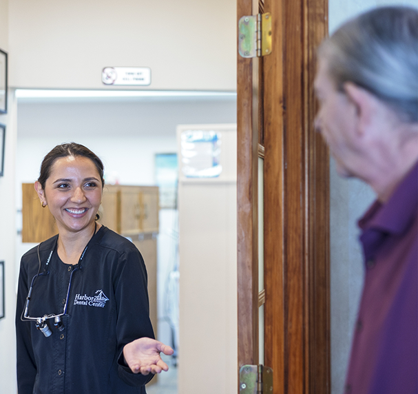 Dental team member greeting patient at door
