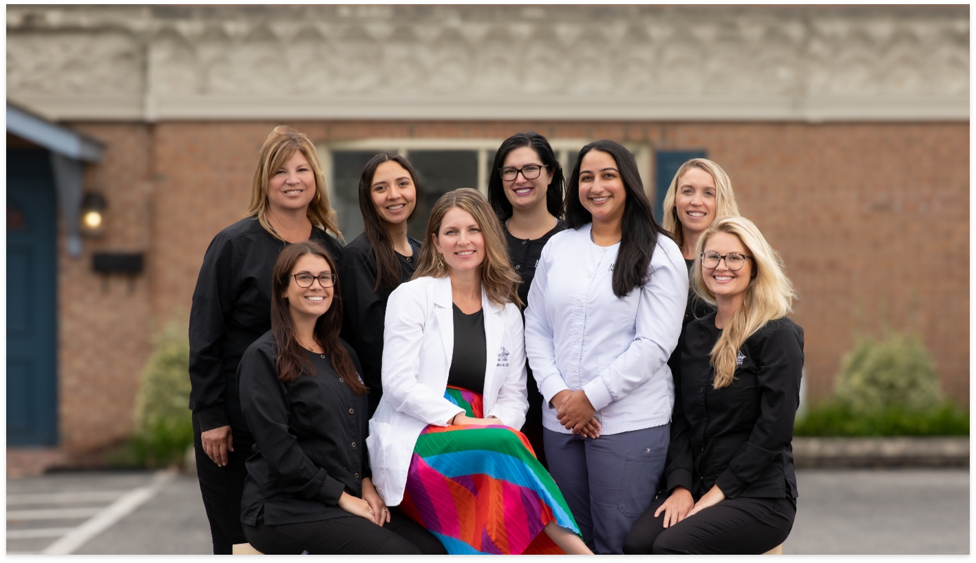 Cambridge dentist and team at Harbor Dental Center smiling