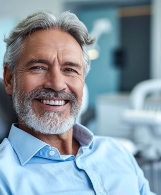 Smiling, mature man in dental treatment chair