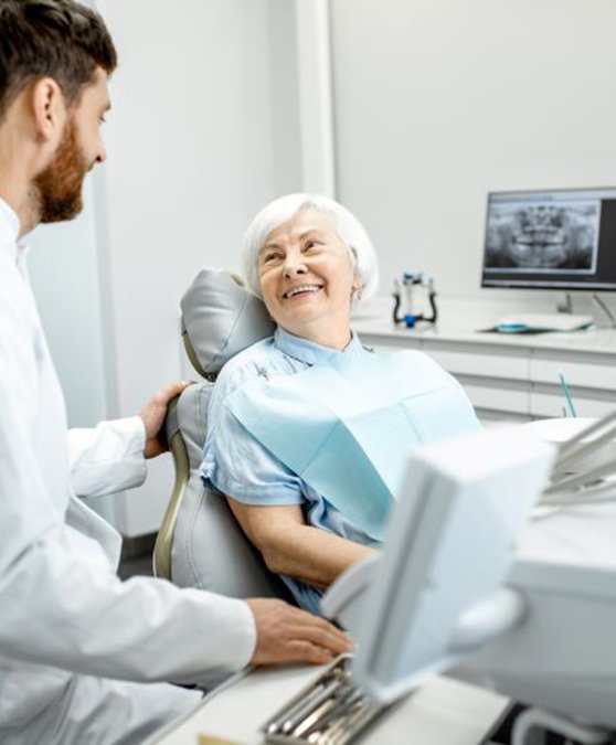 Dentist and patient having friendly conversation