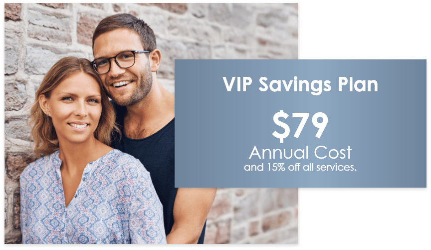 Couple next to a sign for a VIP Savings Plan, costing $79 annually and 15% off all services.