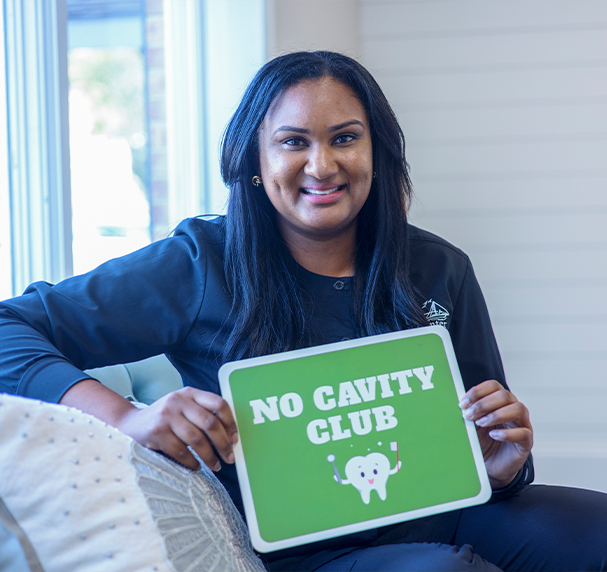 Woman holding sign that says No Cavity Club